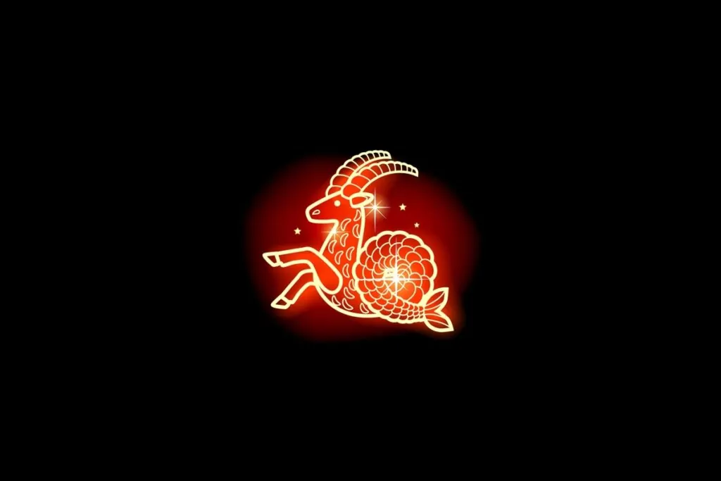 Ilustração em vermelho neon do signo de Capricórnio em fundo preto
