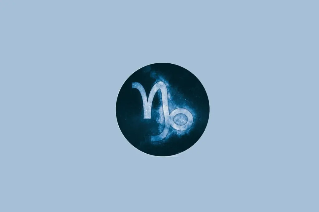 Ilustração do signo de Capricórnio, em fundo azulado, com símbolo que lembra uma combinação de N e espiral