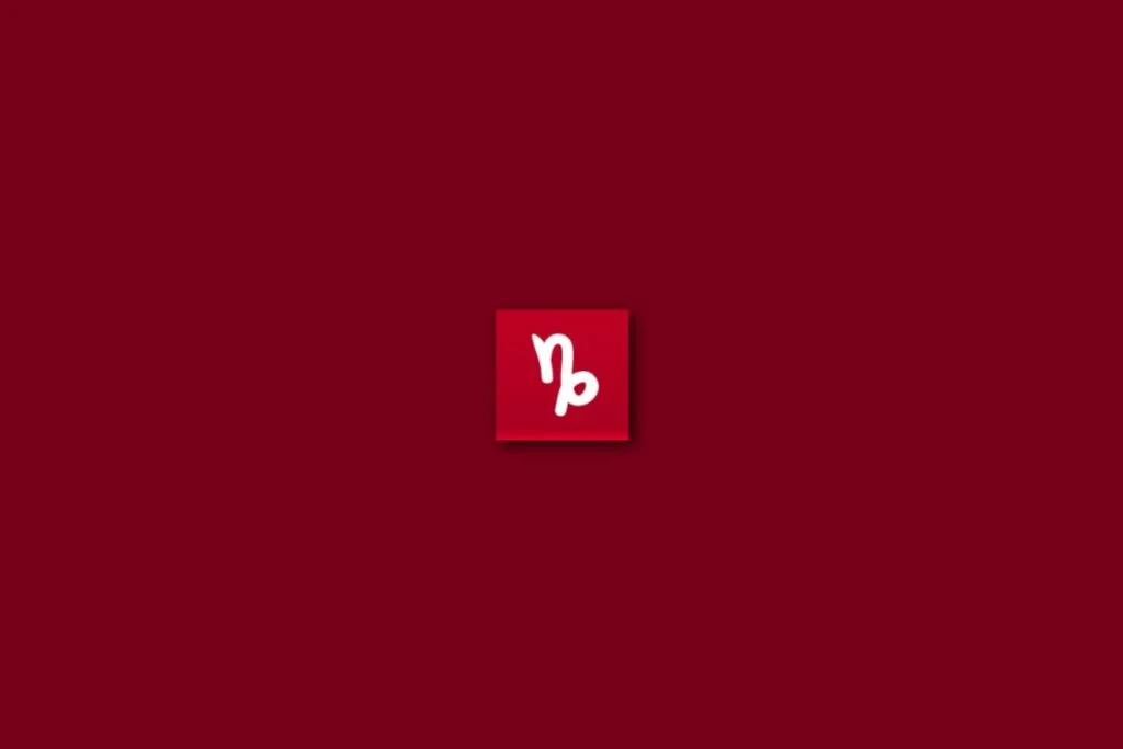 Ilustração branca do signo de capricórnio em um fundo vermelho