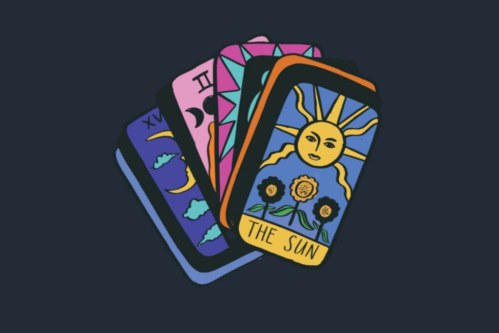 Cartas de Baralho Cigano coloridas dispostas em fundo escuro