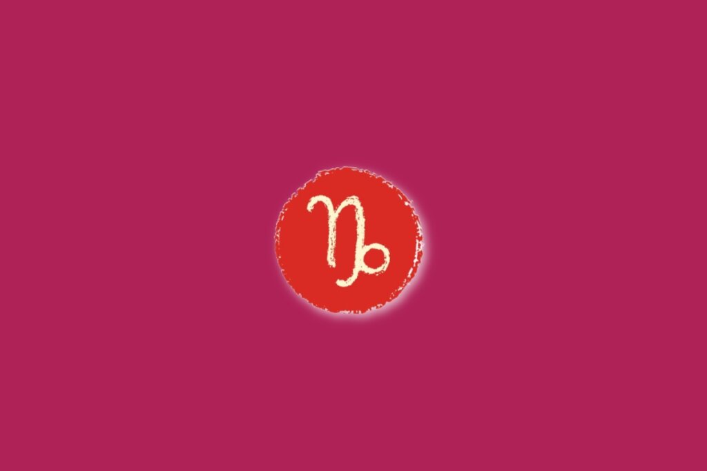 Ilustração do signo de capricórnio, dentro de um círculo vermelho, sobre um fundo rosa