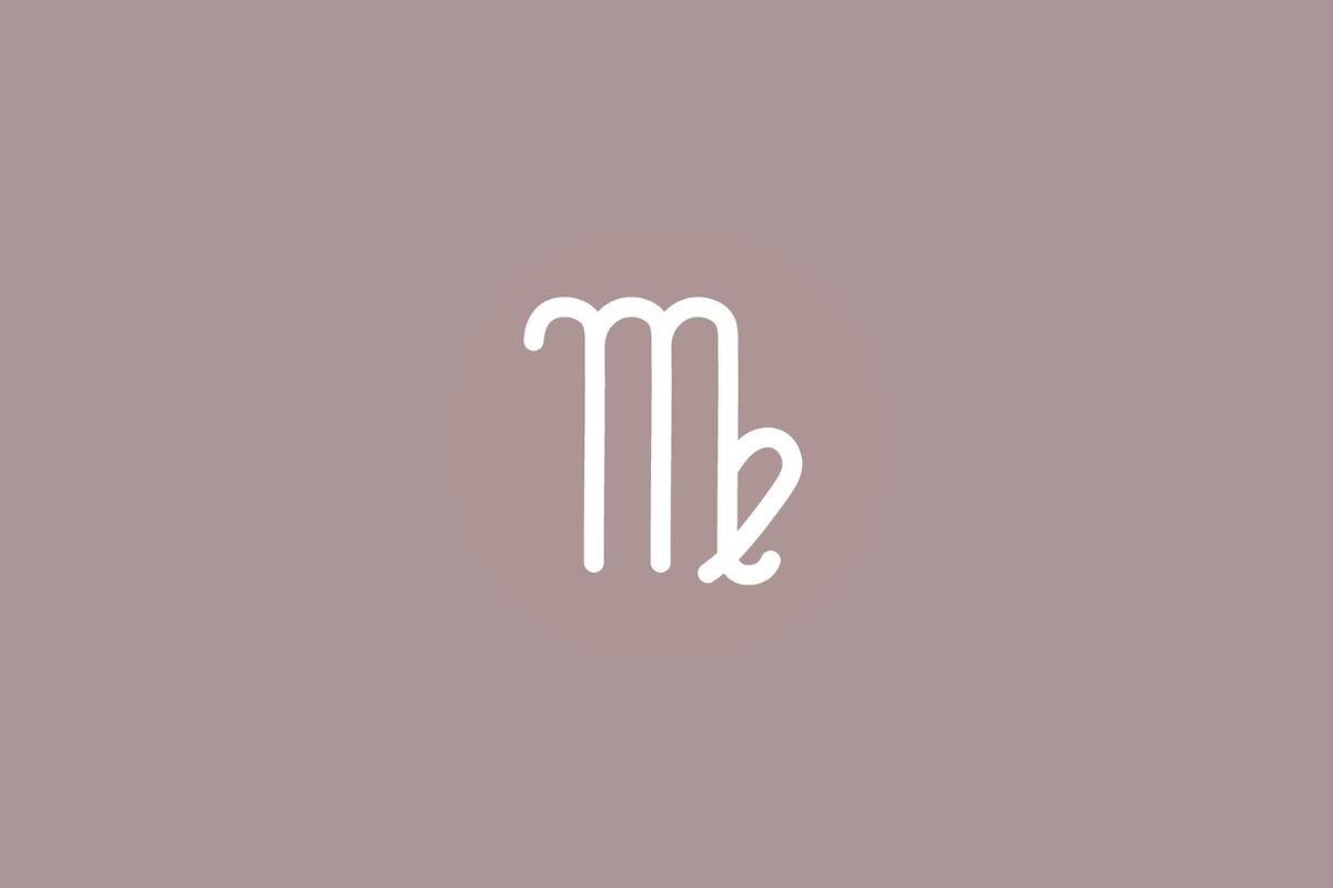 Imagem de fundo castanho-rosado suave. Ao centro, o símbolo branco de Virgem assemelha-se à letra minúscula "m" com três hastes verticais; a última haste dobra-se para dentro e cruza-se num laço arredondado voltado para baixo