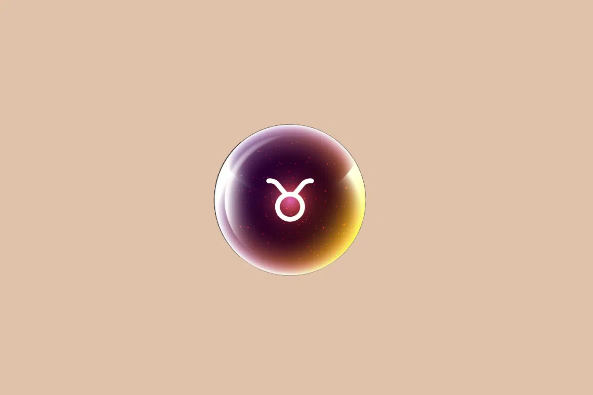 Ilustração do signo de Touro, em fundo bege, contendo o símbolo do signo em branco, em forma de círculo com dois chifres, no centro de uma esfera luminosa