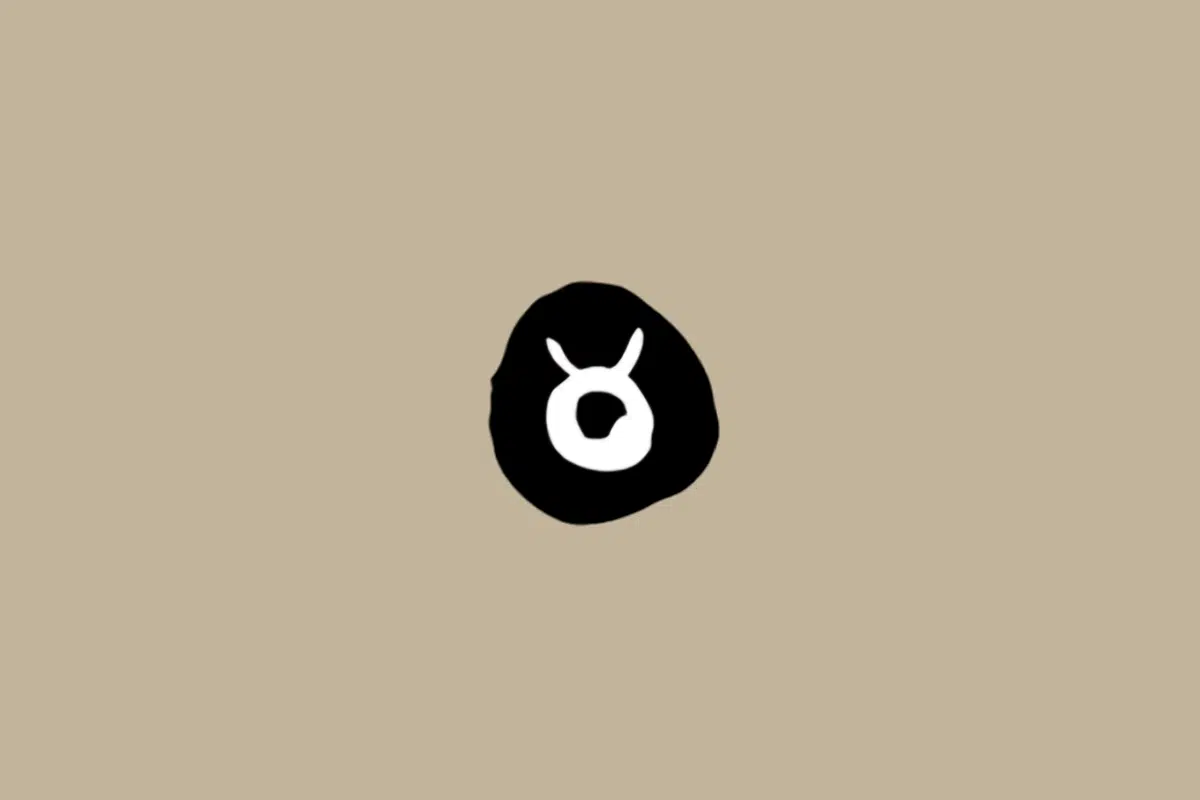 Símbolo do signo de Touro em branco dentro de um círculo preto sobre um fundo bege